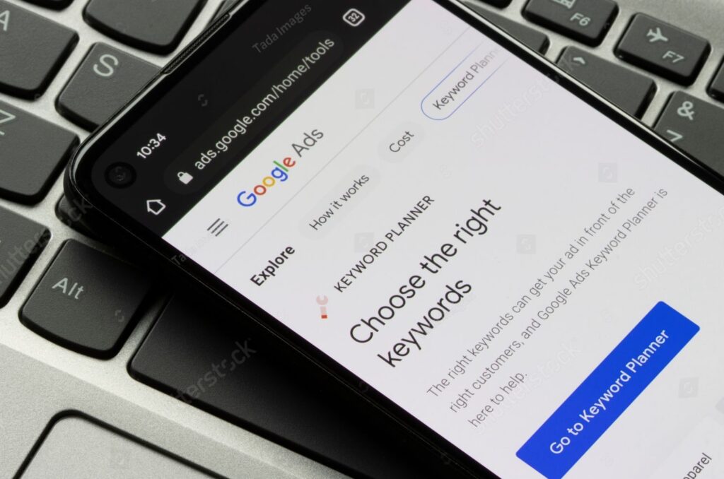A screenshot of a phone screen showing how to use the Google Ads Keyword Planner tool for PPC keywords 